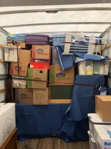 Boxes in a cargo hold with cargo protection coverage from MVM Moving & Storage