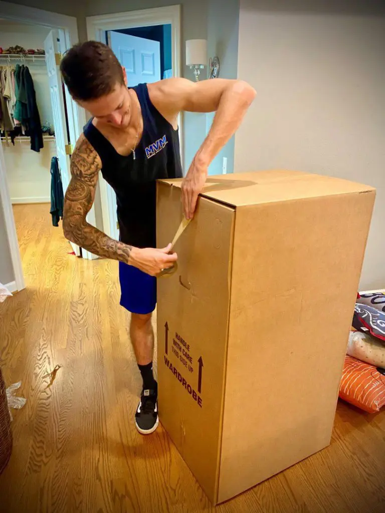 MVM Moving & Storage employee taping a box for a move