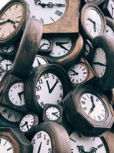Clocks in a pile representing moving on short notice