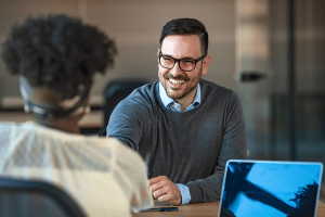 Business associates shaking hands at a desk