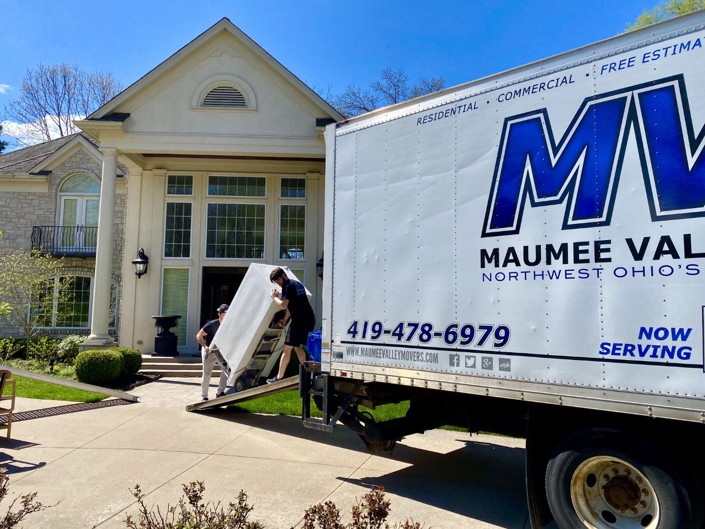 MVM movers loading large items into MVM truck