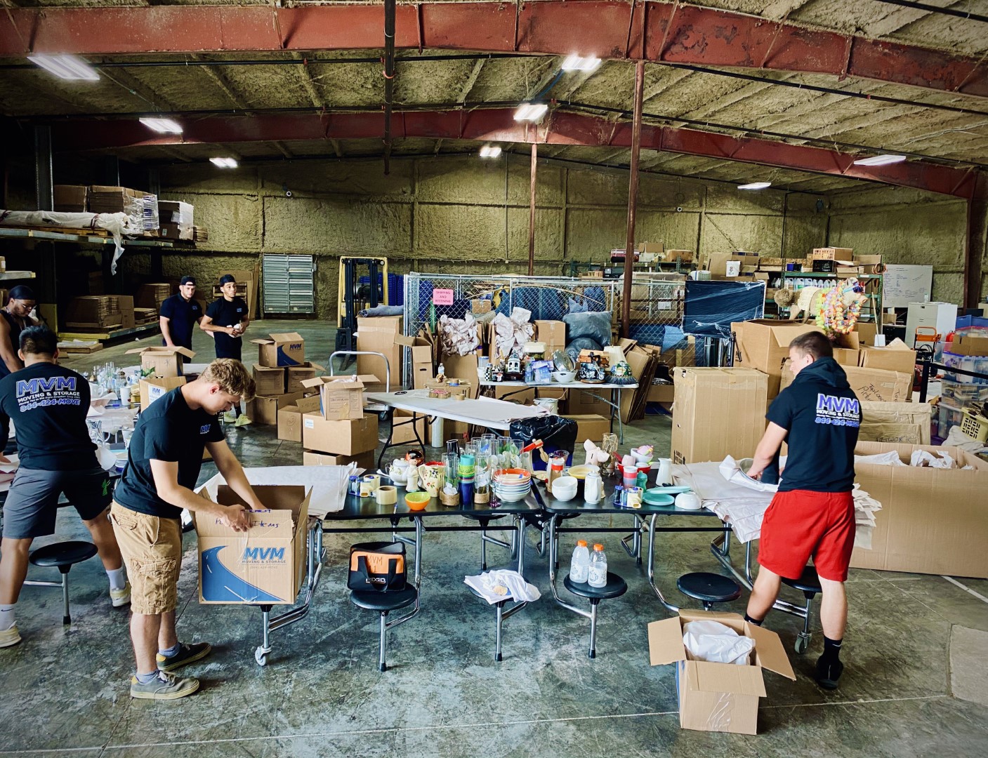 MVM movers packaging small items in a warehouse
